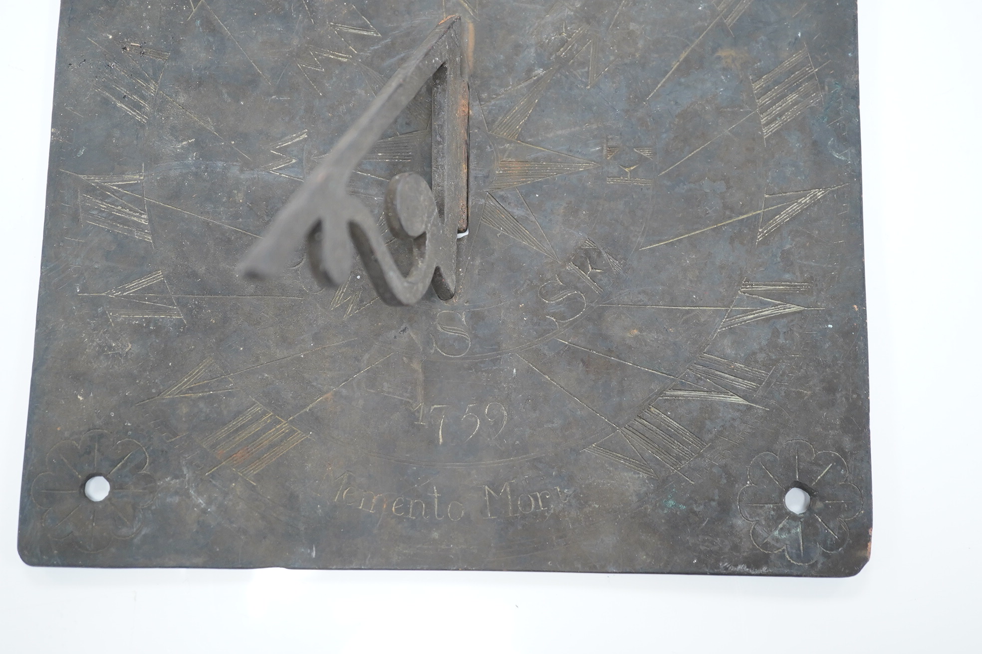 A brass sun dial dated 1759 and engraved ‘Memento Mori’, 20.5cmsq. Condition- good
